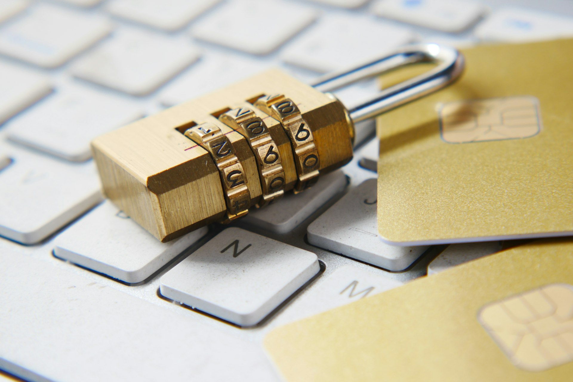 Golden padlock on a computer keyboard representing cybersecurity protection for auto dealerships