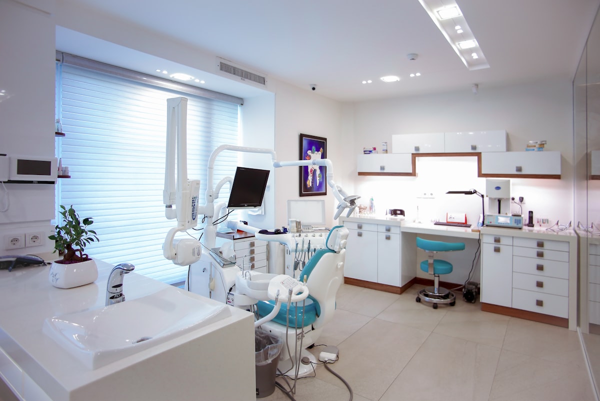 Dental assistant and dentist using tablet technology in a modern dental office