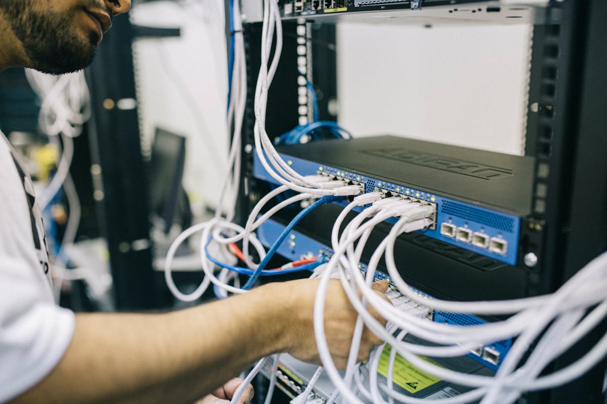 IT engineer working on server cables in a professional data center
