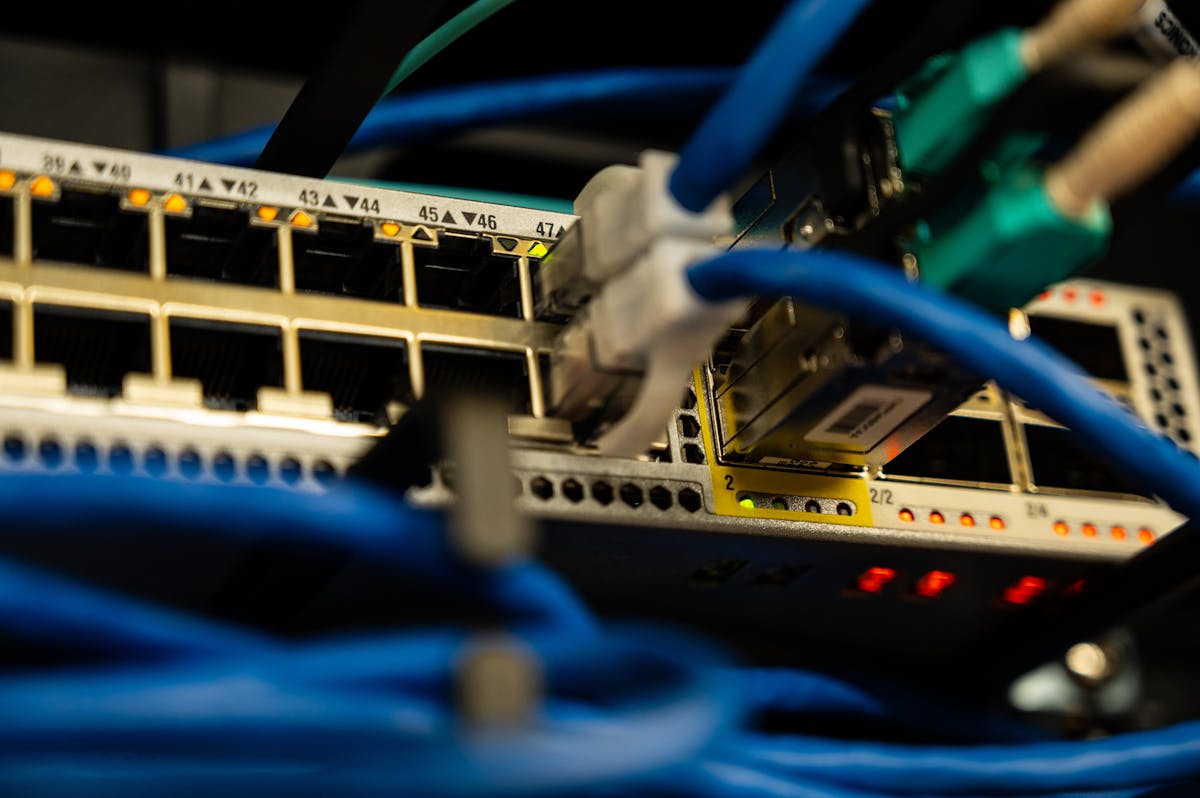 Ethernet cables plugged into a network switch for cloud-managed WiFi infrastructure